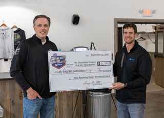 photo of Scott Schreiner and Greg Roth holding a check