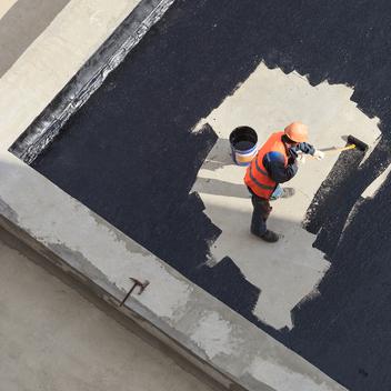 photo of worker waterproofing with roll-on waterproofing agent