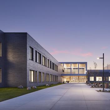 Sunset view of Sartell High School with emphasis on brick exterior