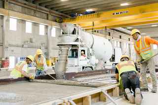 employees in a precast facility creating a panel
