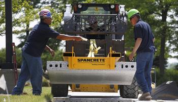 image of two workers with machinery