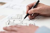 image of person working on a blueprint