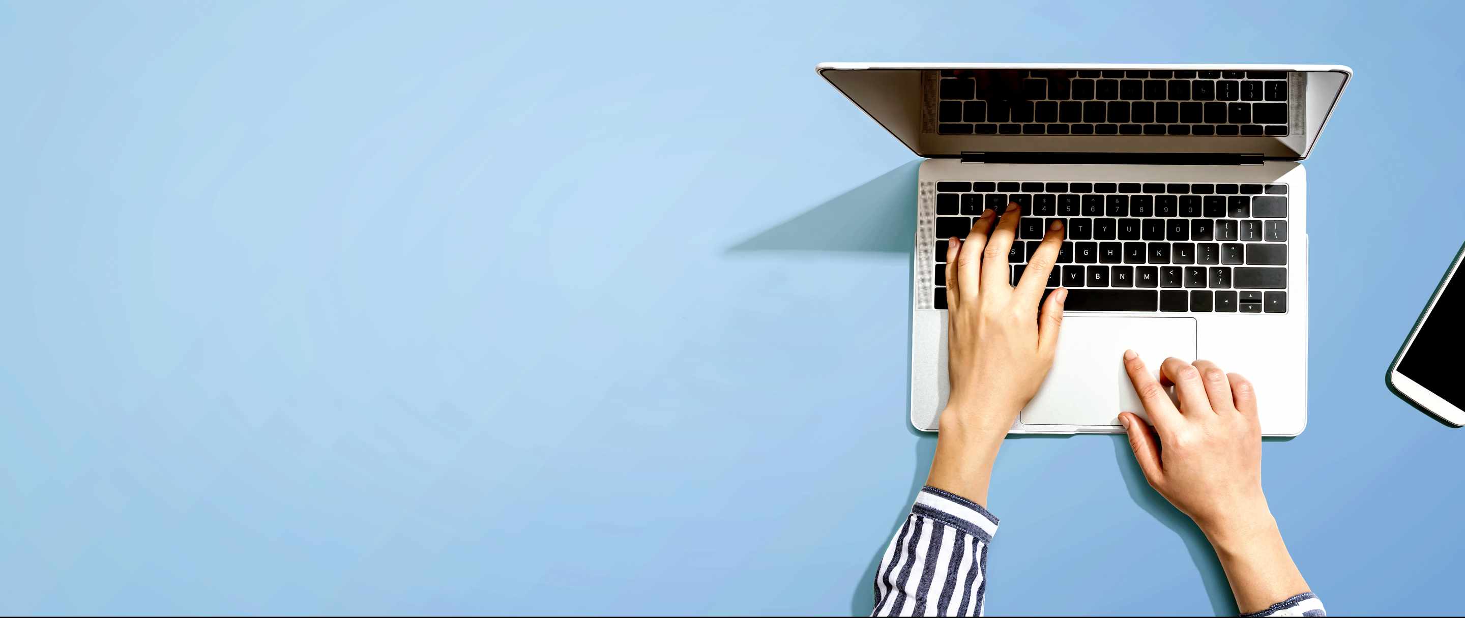 image of someone working on a laptop with blue background